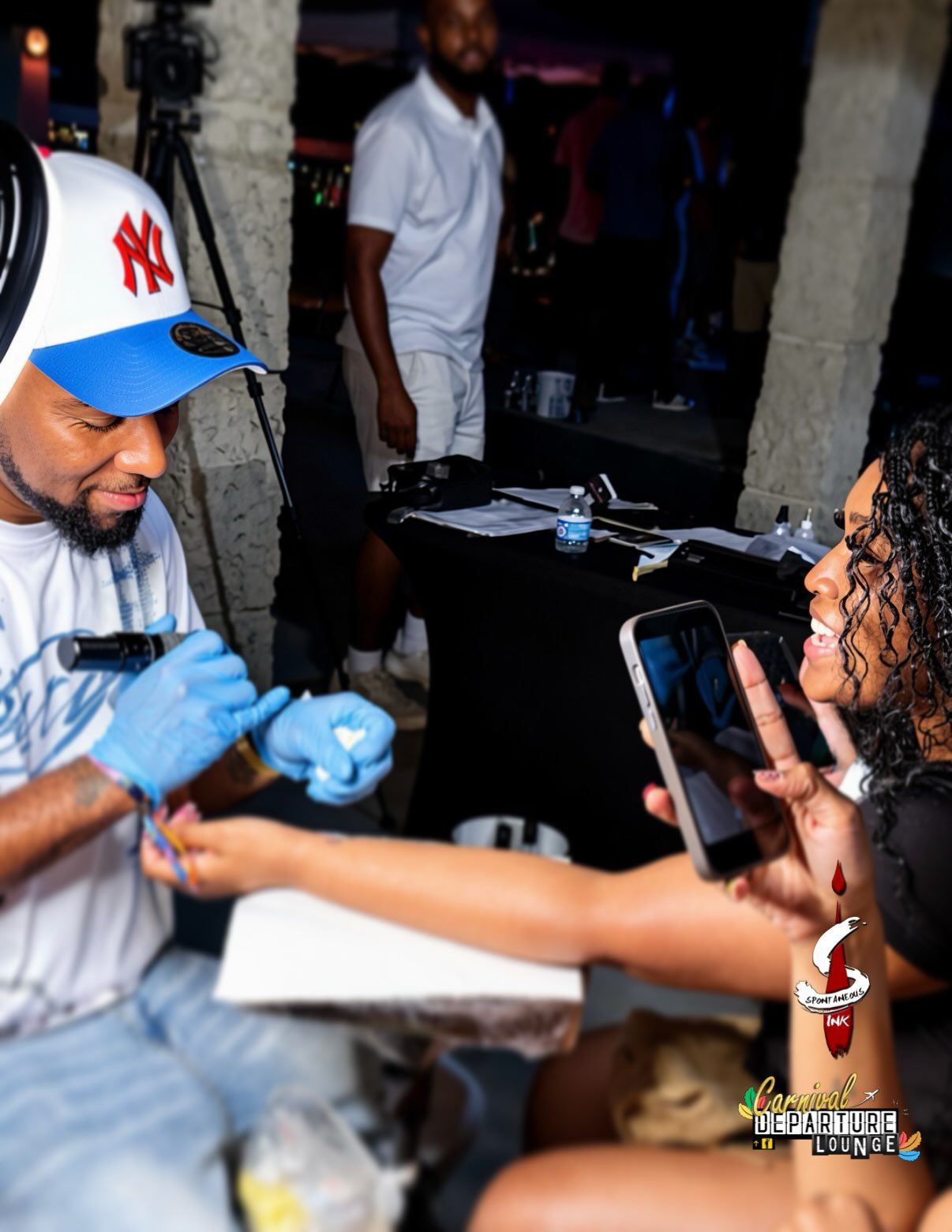 Tattooing at a Carnival Departure Lounge event under the Spontaneous Ink banner