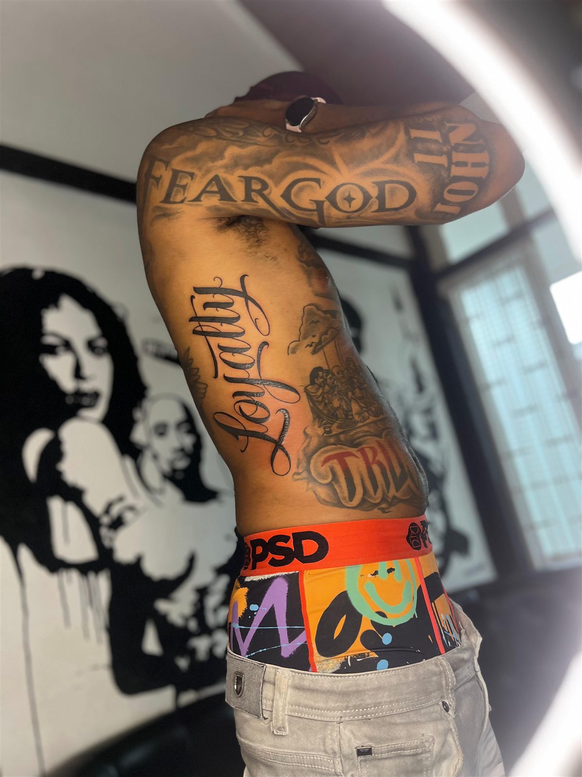 Script and blackletter lettering across ribs and arm