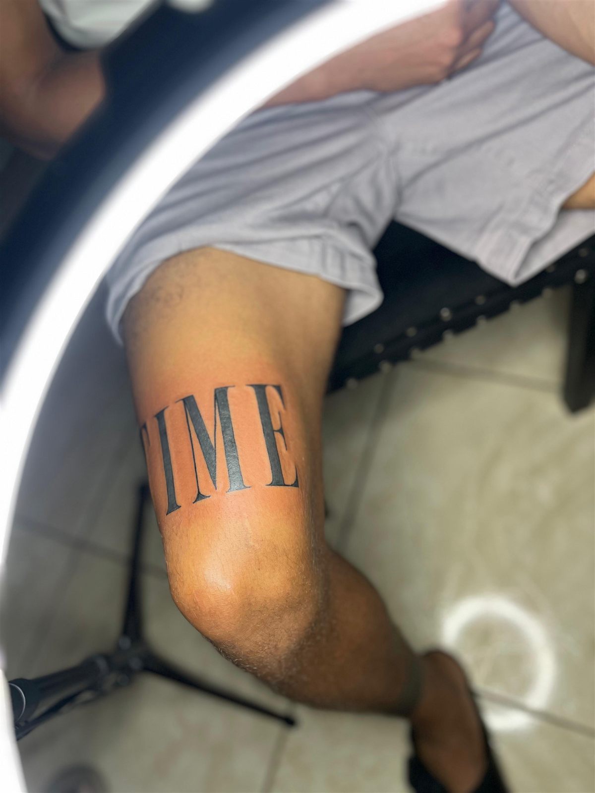 TIME in bold serif lettering, bicep