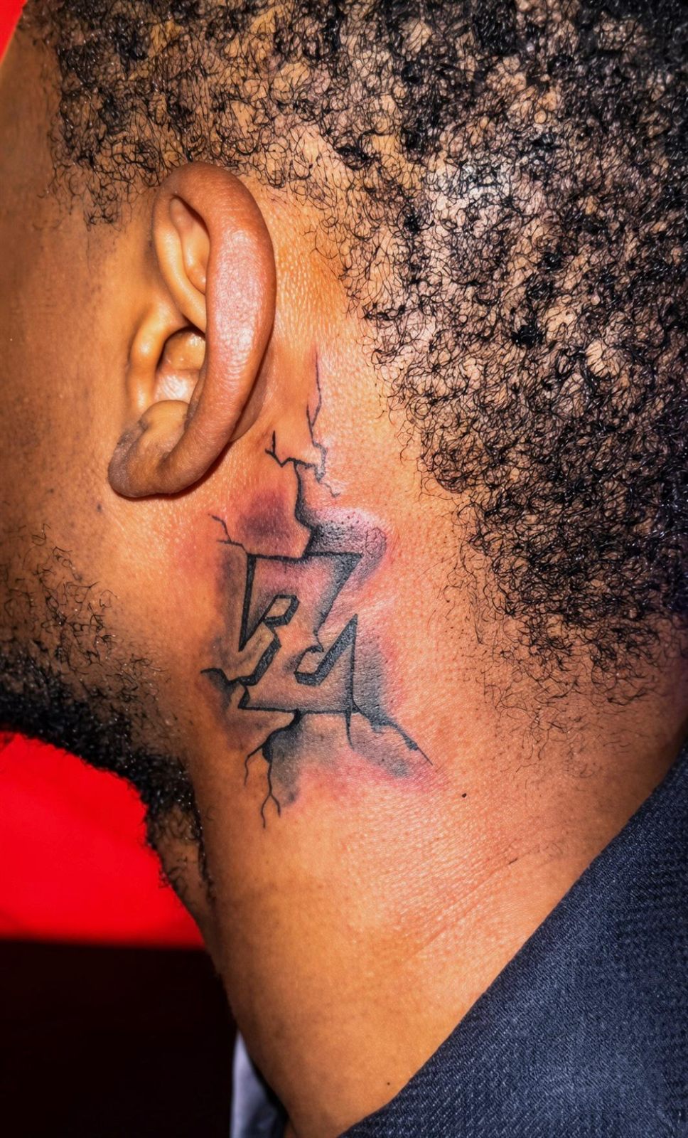 Cracked monogram lettering behind the ear